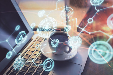 Computer on desktop with social network hologram. Multi exposure. Concept of international people connections.