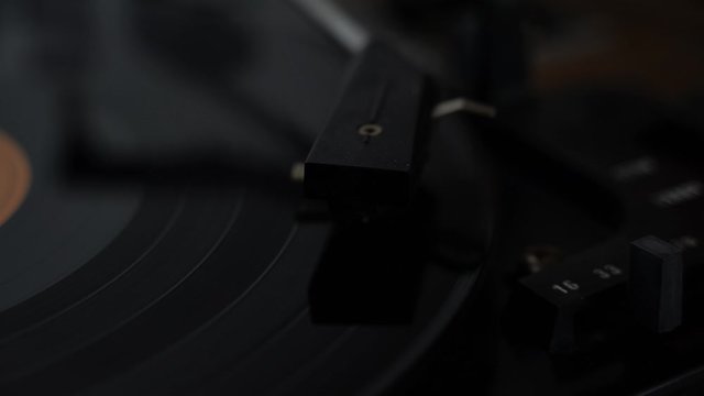 Finger putting needle on record