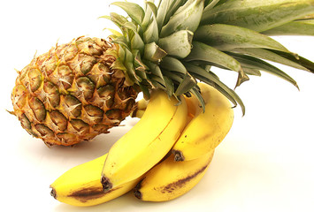Ripe pineapple and bananas close-up isolated on a white background © revo9