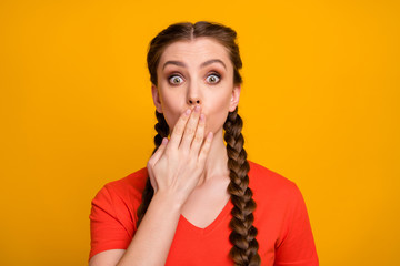 Photo of shocked pretty teen lady hold arm on mouth hiding amazed facial expression bad news epic fail made mistake wear casual red t-shirt isolated vivid yellow color background