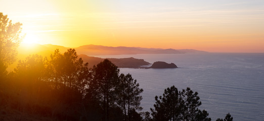 Fototapeta na wymiar Sunset in the Cantabrian Sea, coast of Gipuzkoa,sun hiding behind Getaria, Euskadi