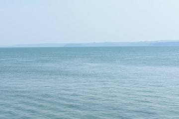 Fototapeta na wymiar a open blue ocean, with a horizon touching sky.
