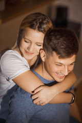 Charming caucasian couple embracing in the kitchen spending time together during the quarantine