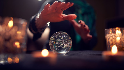 Close-up of woman fortune-teller's hands with ball of predictions