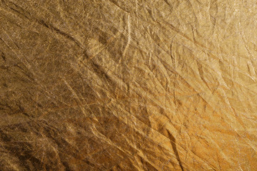 golden foil or fabric, texture suitable for gold leaf, photo reflector or foil