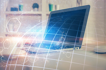 Multi exposure of table with computer and world map hologram. International data network concept.