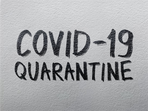 "Covid-19 quarantine" on textured wall  background
