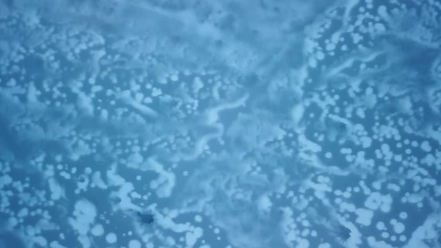 beautiful lake that is frozen, aerial drone view, blue pattern in the Ice