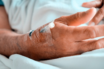 Medical Care, Close up image of IV drip in patient's hand in hospital.