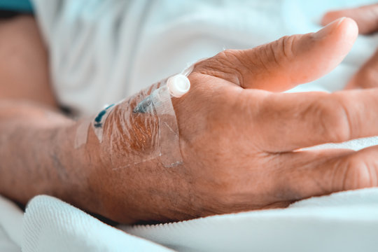 Medical Care, Close up image of IV drip in patient's hand in hospital.