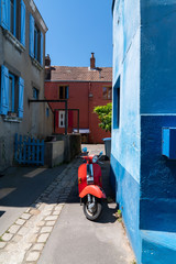 little colorful alley with vintage scooter in Reze Trentemoult village France