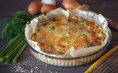 Quiche Loren pie with broccoli, green beans and chicken, sprinkled with sesame seeds