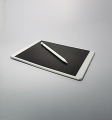 taplet and pencil on white background