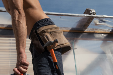 Close up tool belt with tools on construction worker at work.