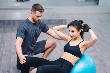 Personal trainer training his client in the gym. Shot of a personal trainer training his client in the gym. - Powered by Adobe