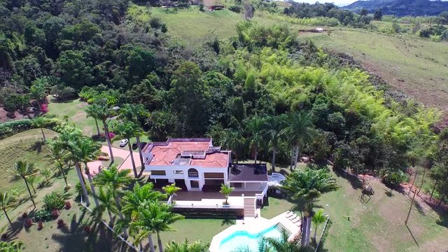 Aerial view to the luxury villa on the Calima lake. Summer time holiday in Colombia, South America. 4K drone video.