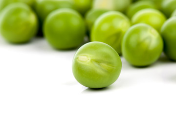 fresh green peas on a white background. Shallow depth of field