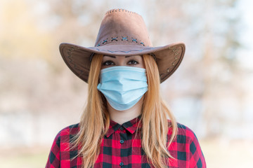 American Woman in mask on street because of air pollution and epidemic in city. Protection against...