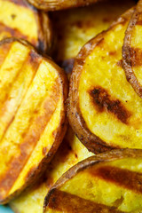 grilled potatoes until golden brown in a blue plate on a yellow background