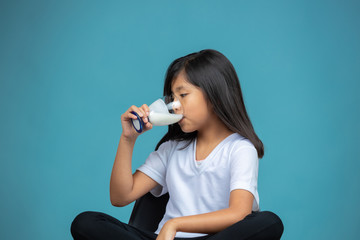 girl drinking a glass of yogurt 
