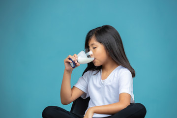 girl drinking a glass of yogurt 