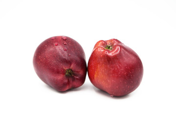 Ripe red organic apples with drops of water isolated on a white background.