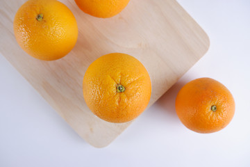 Fresh orange fruit on wooden white background