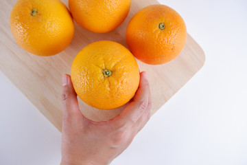 Fresh orange fruit on wooden white background