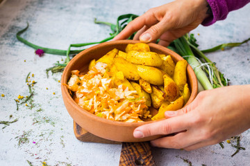 Baked grilled potato slices with fresh cabbage and carrot salad. Vegan, vegetarian dinner, lunch with vegetables.