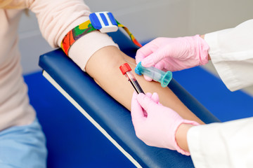 Nurse taking blood sample.