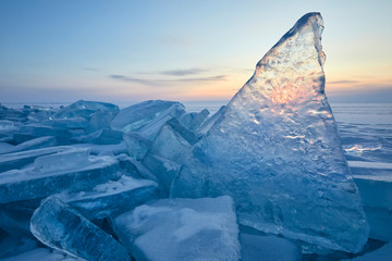 Lake Baikal. A transparent ice floe stands upright at dawn