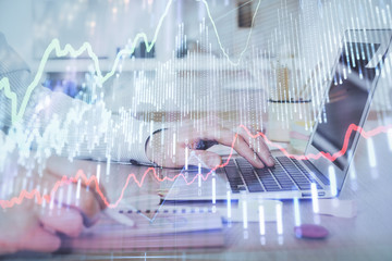 Multi exposure of stock market chart with man working on computer on background. Concept of financial analysis.