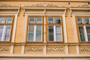 Brasov, Romania, 4 march 2020, photo of old beautiful windows on yellow wall