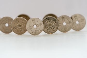 ULSTEINVIK, NORWAY - 2020 MARCH 18. Norwegian Kroner coins standing on a white table..