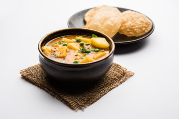 Aloo Puri or Potato curry with fried Poori, popular Indian breakfast / lunch / dinner menu.