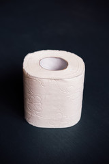 White soft texture toilet paper (one roll) on a dark background.