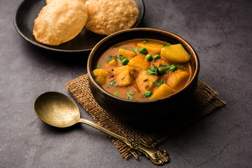 Aloo Puri or Potato curry with fried Poori, popular Indian breakfast / lunch / dinner menu.