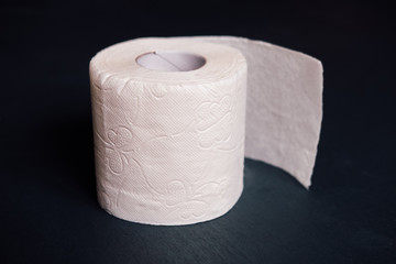 White soft texture toilet paper (one roll) on a dark background.