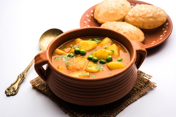 Aloo Puri or Potato curry with fried Poori, popular Indian breakfast / lunch / dinner menu.