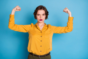 Girls power. Photo of pretty serious lady hold raise biceps two hands showing perfect biceps after...