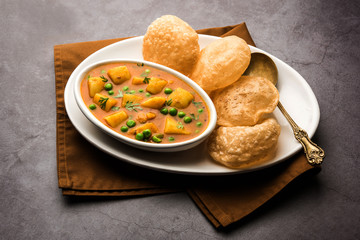 Aloo Puri or Potato curry with fried Poori, popular Indian breakfast / lunch / dinner menu.