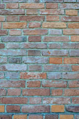 Old brick wall of weathered brick of different colors as a background