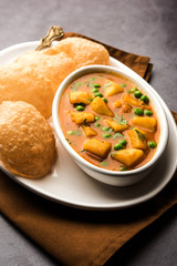 Aloo Puri or Potato curry with fried Poori, popular Indian breakfast / lunch / dinner menu.