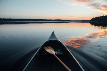Scenic view of canoe in lake during sunset