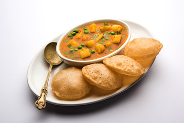 Aloo Puri or Potato curry with fried Poori, popular Indian breakfast / lunch / dinner menu.