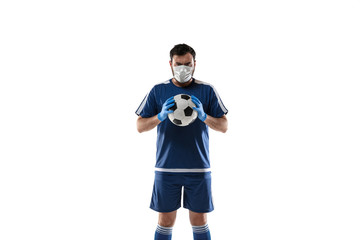 Obraz premium Punching virus. Football, soccer player in protective mask and gloves. Prevention against pneumonia. Still active while quarantine. Chinese coronavirus treatment. Healthcare, medicine, sport concept.