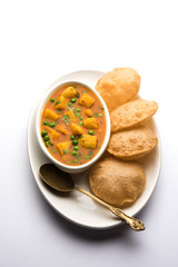 Aloo Puri or Potato curry with fried Poori, popular Indian breakfast / lunch / dinner menu.