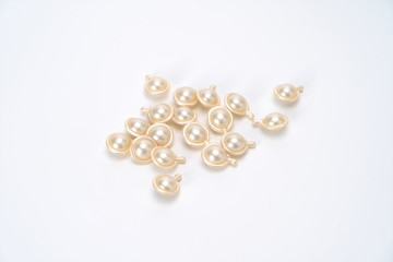 Fragrant beads in the shape of silvery water droplets on a white background