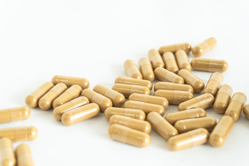 brown medicine herb pill on white background