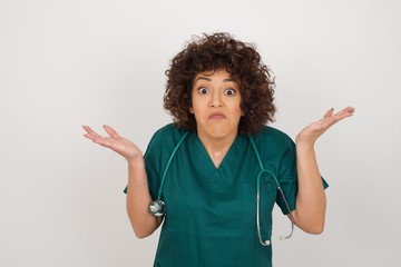 Beautiful doctor woman doubt expression, confuse and wonder concept, uncertain future shrugging...